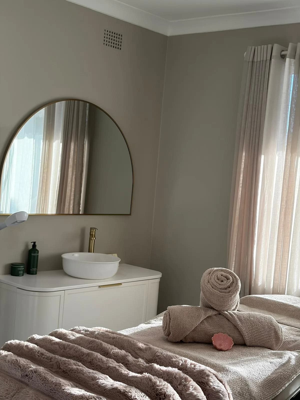 The Inner Balance treatment room, with an arched mirror and soft natural light